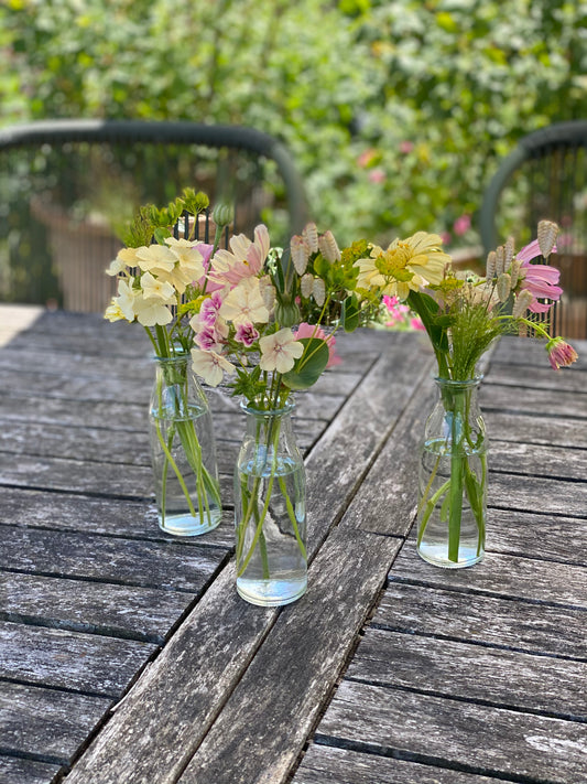 Filled table vases with fresh flowers